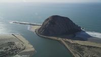 5K stock footage aerial video of flying by Morro Rock beside the ocean, Morro Bay, California Aerial Stock Footage | DFKSF16_156