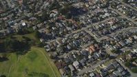 5K stock footage aerial video of a reverse view of suburban homes, reveal Morro Bay Golf Course, California Aerial Stock Footage | DFKSF16_158