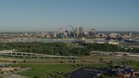 5.7K stock footage aerial video of freeway and park in East St. Louis, looking toward Arch and skyline, sunrise, Downtown St. Louis, Missouri Aerial Stock Footage | DX0001_000549