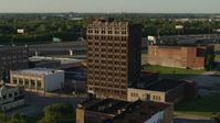 5.7K stock footage aerial video of flying away from an abandoned office building at sunset, East St. Louis, Illinois Aerial Stock Footage | DX0001_000674
