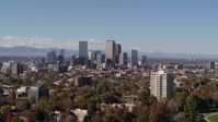 5.7K stock footage aerial video ascend to wider view of the city's skyline, seen from park with trees, Downtown Denver, Colorado Aerial Stock Footage | DX0001_001732