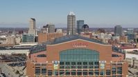 5.7K stock footage aerial video of flying by the football stadium, ascend to reveal skyline in Downtown Indianapolis, Indiana Aerial Stock Footage | DX0001_002824