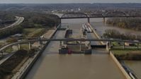 5.7K stock footage aerial video flying by locks and a dam on the Ohio River in Louisville, Kentucky Aerial Stock Footage | DX0001_003012