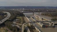 5.7K stock footage aerial video flying by railroad bridge near locks and a dam on the Ohio River in Louisville, Kentucky Aerial Stock Footage | DX0001_003016
