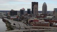5.7K stock footage aerial video ascend over freeway with view of skyscrapers in Downtown Louisville, Kentucky Aerial Stock Footage | DX0001_003024