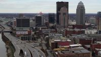 5.7K stock footage aerial video fly away from skyscrapers in Downtown Louisville, Kentucky, descend by freeway Aerial Stock Footage | DX0001_003025