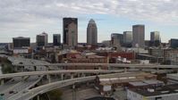 5.7K stock footage aerial video ascend over freeway to approach the city skyline in Downtown Louisville, Kentucky Aerial Stock Footage | DX0001_003026