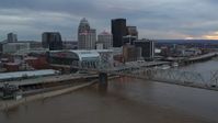 5.7K stock footage aerial video of arena and city skyline seen from bridge spanning river at sunset, Downtown Louisville, Kentucky Aerial Stock Footage | DX0001_003065