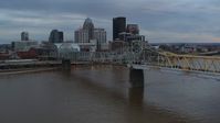 5.7K stock footage aerial video descend by bridge with view of the skyline at sunset, Downtown Louisville, Kentucky Aerial Stock Footage | DX0001_003067
