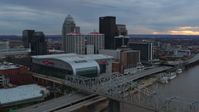 5.7K stock footage aerial video flyby bridge and ascend near arena and skyline at sunset, Downtown Louisville, Kentucky Aerial Stock Footage | DX0001_003068