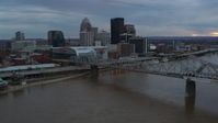 5.7K stock footage aerial video of the arena and skyline, seen while flying by bridge and Ohio River at sunset, Downtown Louisville, Kentucky Aerial Stock Footage | DX0001_003070