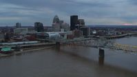 5.7K stock footage aerial video fly over the river to approach arena and city skyline at sunset, Downtown Louisville, Kentucky Aerial Stock Footage | DX0001_003076