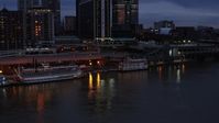 5.7K stock footage aerial video orbit small riverboat beside a historic ship at twilight in Downtown Louisville, Kentucky Aerial Stock Footage | DX0001_003095