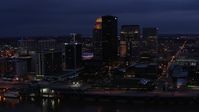 5.7K stock footage aerial video reverse view of the city's skyline at twilight, reveal Ohio River, Downtown Louisville, Kentucky Aerial Stock Footage | DX0001_003108