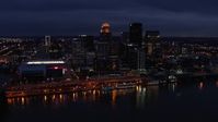 5.7K stock footage aerial video slowly fly away from and by the city's skyline at twilight, seen from Ohio River, Downtown Louisville, Kentucky Aerial Stock Footage | DX0001_003111