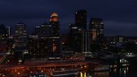 5.7K stock footage aerial video reverse view of hotel and the city skyline at twilight, reveal river, Downtown Louisville, Kentucky Aerial Stock Footage | DX0001_003115