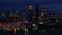 5.7K stock footage aerial video cross the Ohio River and ascend toward the city skyline at twilight, Downtown Louisville, Kentucky Aerial Stock Footage | DX0001_003117