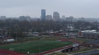 5.7K stock footage aerial video of the city skyline seen while descending by football field, Downtown Lexington, Kentucky Aerial Stock Footage | DX0001_003209