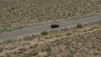 5.7K stock footage aerial video of tracking a black SUV on a desert road in Carson City, Nevada Aerial Stock Footage | DX0001_007_019