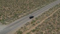5.7K stock footage aerial video approach a black SUV parked on a desert road in Carson City, Nevada Aerial Stock Footage | DX0001_007_020