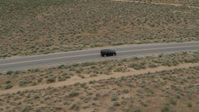 5.7K stock footage aerial video track a black SUV as it drives on a desert road in Carson City, Nevada Aerial Stock Footage | DX0001_007_022