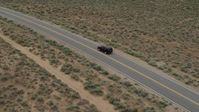 5.7K stock footage aerial video track a black SUV as travels on a desert road in Carson City, Nevada Aerial Stock Footage | DX0001_007_024