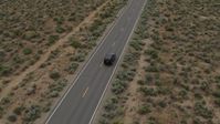 5.7K stock footage aerial video of a black SUV pulling onto a desert road in Carson City, Nevada Aerial Stock Footage | DX0001_007_026