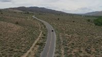 5.7K stock footage aerial video of a black SUV cruising on a desert road in Carson City, Nevada Aerial Stock Footage | DX0001_007_027