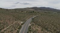 5.7K stock footage aerial video of following a black SUV cruising on a desert road in Carson City, Nevada Aerial Stock Footage | DX0001_007_028