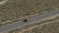 5.7K stock footage aerial video of a black SUV driving on a desert road in Carson City, Nevada Aerial Stock Footage | DX0001_007_029