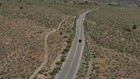 5.7K stock footage aerial video of a black SUV driving on a lonely desert road in Carson City, Nevada Aerial Stock Footage | DX0001_007_030