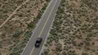 5.7K stock footage aerial video of revealing a black truck driving on a desert road in Carson City, Nevada Aerial Stock Footage | DX0001_007_031