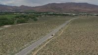 5.7K stock footage aerial video approach a black SUV driving to the side of the road in Carson City, Nevada Aerial Stock Footage | DX0001_007_034