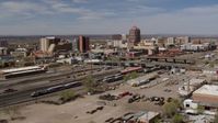 5.7K stock footage aerial video passing railroad tracks with view of Albuquerque Plaza and surrounding buildings, Downtown Albuquerque, New Mexico Aerial Stock Footage | DX0002_124_029