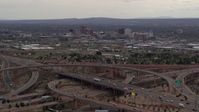 5.7K stock footage aerial video of Downtown Albuquerque buildings seen while passing freeway interchange traffic, New Mexico Aerial Stock Footage | DX0002_126_030