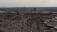 5.7K stock footage aerial video of Downtown Albuquerque buildings seen while descending by freeway interchange traffic, New Mexico Aerial Stock Footage | DX0002_126_031