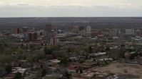 5.7K stock footage aerial video reverse view of city's high-rise buildings seen from neighborhood, Downtown Albuquerque, New Mexico Aerial Stock Footage | DX0002_126_037