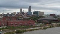 5.7K stock footage aerial video of the city's skyline and riverfront apartment complex seen from river, Downtown Omaha, Nebraska Aerial Stock Footage | DX0002_169_035