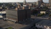 5.7K stock footage aerial video of a stationary view of a brick office building at sunset, Downtown Omaha, Nebraska Aerial Stock Footage | DX0002_170_047