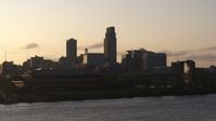5.7K stock footage aerial video the skyline at sunset, seen from the river, Downtown Omaha, Nebraska Aerial Stock Footage | DX0002_172_011