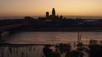 5.7K stock footage aerial video a view of the skyline while descending by the river at twilight, Downtown Omaha, Nebraska Aerial Stock Footage | DX0002_172_044