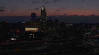 5.7K stock footage aerial video of flying away from the city's skyline at twilight, Downtown Omaha, Nebraska Aerial Stock Footage | DX0002_173_008