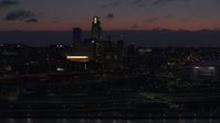 5.7K stock footage aerial video of a reverse view of the city's skyline at twilight, reveal the river, Downtown Omaha, Nebraska Aerial Stock Footage | DX0002_173_009