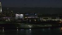 5.7K stock footage aerial video approach arena and convention center complex from river at night, Downtown Omaha, Nebraska Aerial Stock Footage | DX0002_173_029