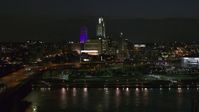5.7K stock footage aerial video of the city's skyline at night, seen while flying over river, Downtown Omaha, Nebraska Aerial Stock Footage | DX0002_173_033