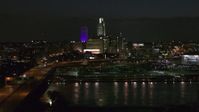 5.7K stock footage aerial video flyby the city's skyline at night, reveal bridge spanning river, Downtown Omaha, Nebraska Aerial Stock Footage | DX0002_173_034