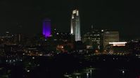 5.7K stock footage aerial video the city's skyscrapers seen from the park at night, Downtown Omaha, Nebraska Aerial Stock Footage | DX0002_173_060