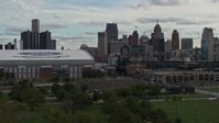 5.7K stock footage aerial video descend behind the stadiums with view of the skyline in Downtown Detroit, Michigan Aerial Stock Footage | DX0002_191_032