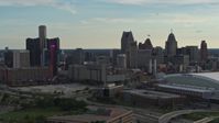 5.7K stock footage aerial video fly away from the skyline at sunset in Downtown Detroit, Michigan, reveal Ford Field Aerial Stock Footage | DX0002_191_037