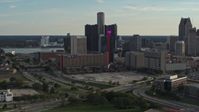 5.7K stock footage aerial video a view of tall skyscrapers and a hotel at sunset while descending in Downtown Detroit, Michigan Aerial Stock Footage | DX0002_191_051